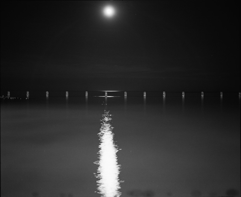 the moon and a line of pilings