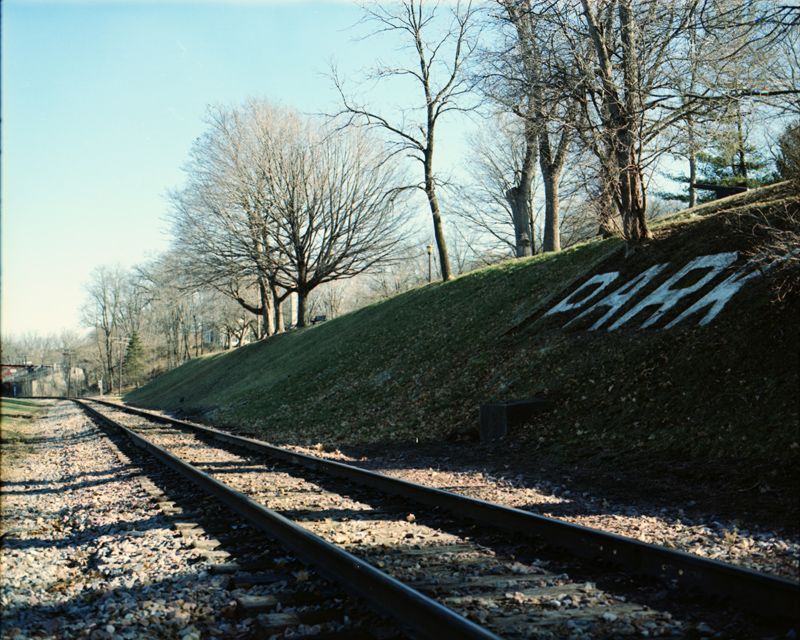 Railroad Tracks and Park Sign