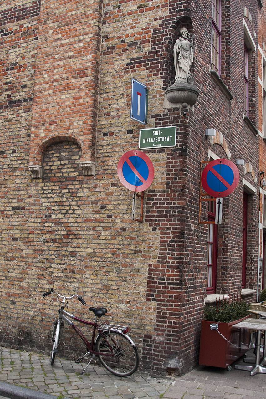 Empty Bruges Corner with Signs and Bike